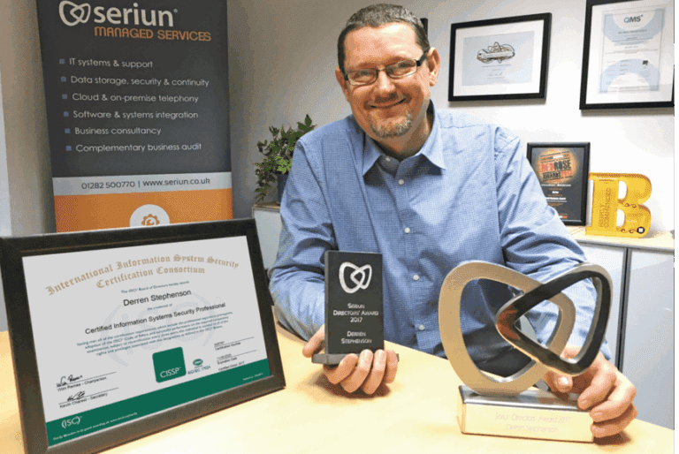 Man posing with awards